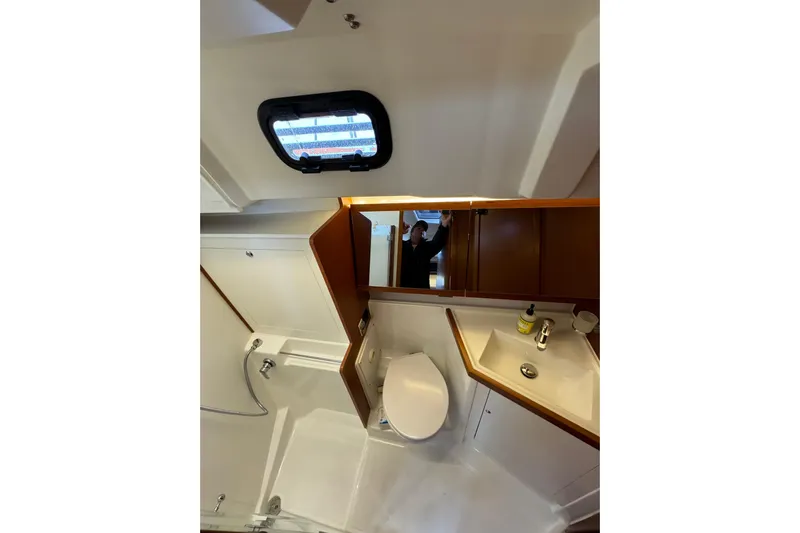 Run For The Roses Yacht Photos Pics Bathroom interior of 2019 Beneteau Oceanis 46.1 yacht, featuring sink and toilet.