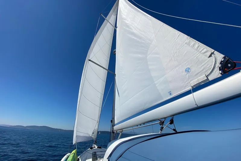 Run For The Roses Yacht Photos Pics 2019 Beneteau Oceanis 46.1 sailing on open sea under clear blue sky.