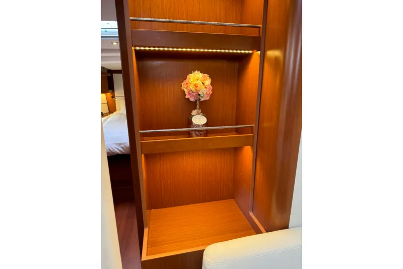 Run For The Roses Yacht Photos Pics Luxurious interior of 2019 Beneteau Oceanis 46.1 yacht with elegant wooden shelving.
