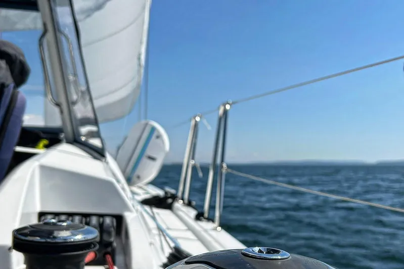 Run For The Roses Yacht Photos Pics 2019 Beneteau Oceanis 46.1 sailing on open water under clear blue skies.