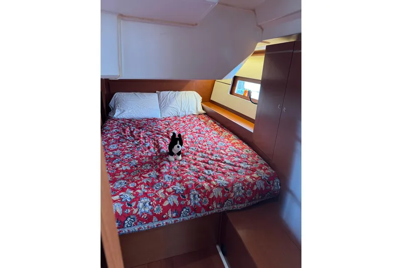 Run For The Roses Yacht Photos Pics Cozy cabin interior of 2019 Beneteau Oceanis 46.1 with floral bedding and plush toy.