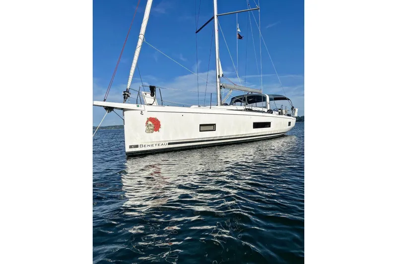 Run For The Roses Yacht Photos Pics 2019 Beneteau Oceanis 46.1 sailboat on calm water, clear blue sky background.