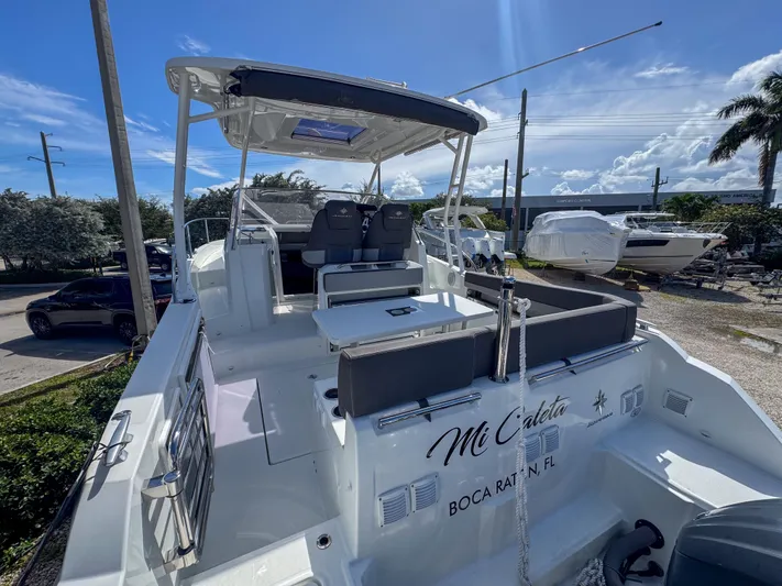 Mi Caleta Yacht Photos Pics 2023 Jeanneau Leader 9.0 WA boat docked in Boca Raton, Florida, under clear blue skies.