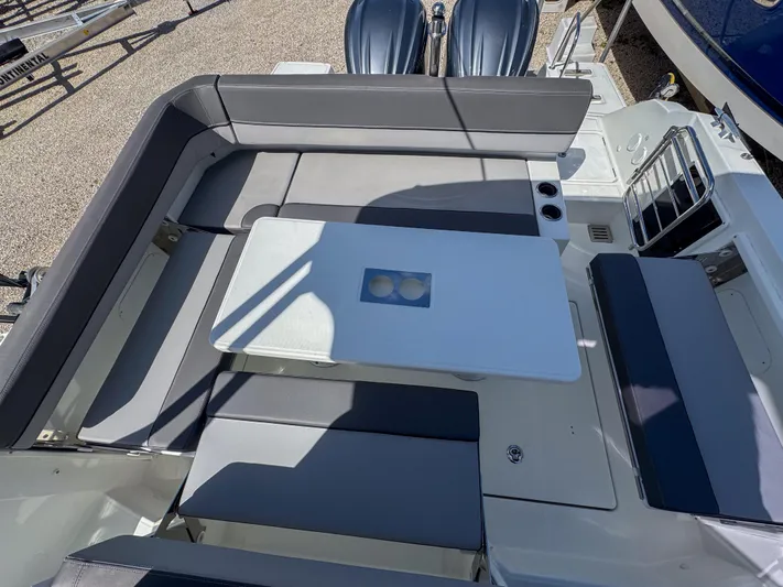 Mi Caleta Yacht Photos Pics 2023 Jeanneau Leader 9.0 WA boat interior with seating and table setup.