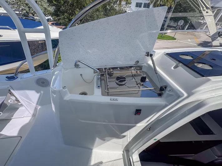 Mi Caleta Yacht Photos Pics 2023 Jeanneau Leader 9.0 WA boat kitchen area with stove and sink.