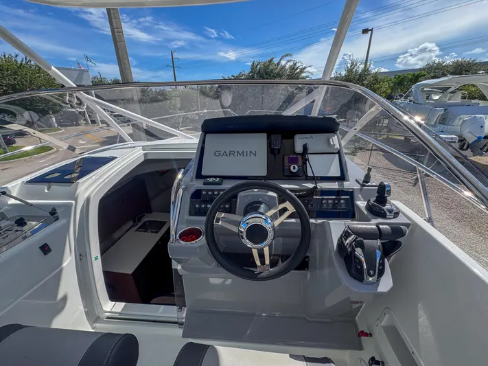 Mi Caleta Yacht Photos Pics 2023 Jeanneau Leader 9.0 WA helm with Garmin navigation system and modern controls.