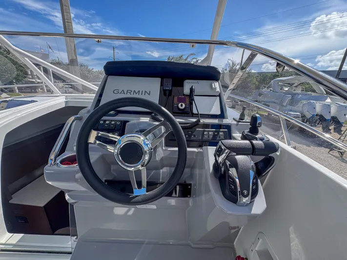 Mi Caleta Yacht Photos Pics 2023 Jeanneau Leader 9.0 WA helm with Garmin navigation system and modern controls.