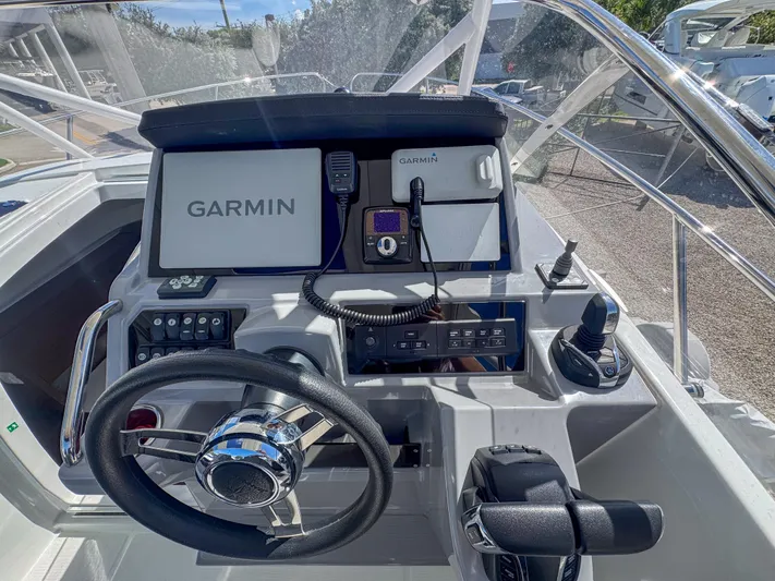Mi Caleta Yacht Photos Pics 2023 Jeanneau Leader 9.0 WA helm with Garmin navigation system and controls.
