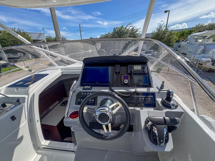 Mi Caleta Yacht Photos Pics 2023 Jeanneau Leader 9.0 WA helm with modern navigation equipment and controls.