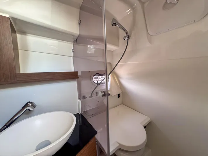 Mi Caleta Yacht Photos Pics 2023 Jeanneau Leader 9.0 WA bathroom with modern sink, shower, and toilet.