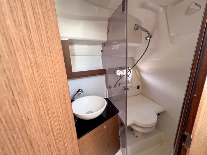 Mi Caleta Yacht Photos Pics 2023 Jeanneau Leader 9.0 WA bathroom with modern fixtures and wooden accents.