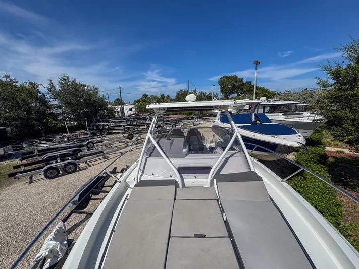 Mi Caleta Yacht Photos Pics 2023 Jeanneau Leader 9.0 WA boat on display with trailers and other boats nearby.