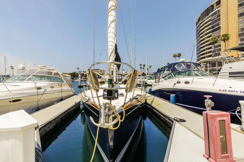 Kamala Yacht Photos Pics Sailboat docked in marina, Tartan 3700, 2003 model, surrounded by other boats.