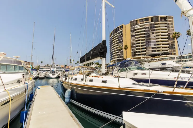 Kamala Yacht Photos Pics Sailboats docked in marina with Tartan 3700, 2003 model, and modern buildings in background.