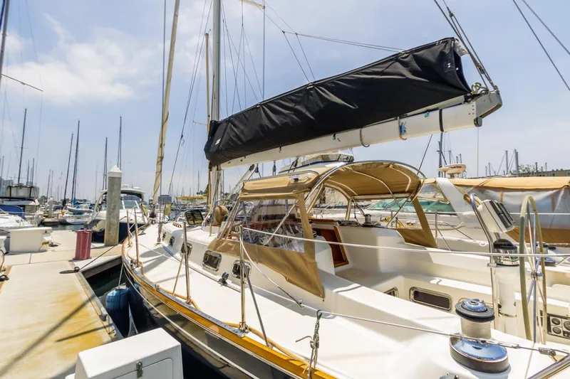 Kamala Yacht Photos Pics Sailboat docked at marina, Tartan 3700 model, 2003, with tan canopy and black sail cover.