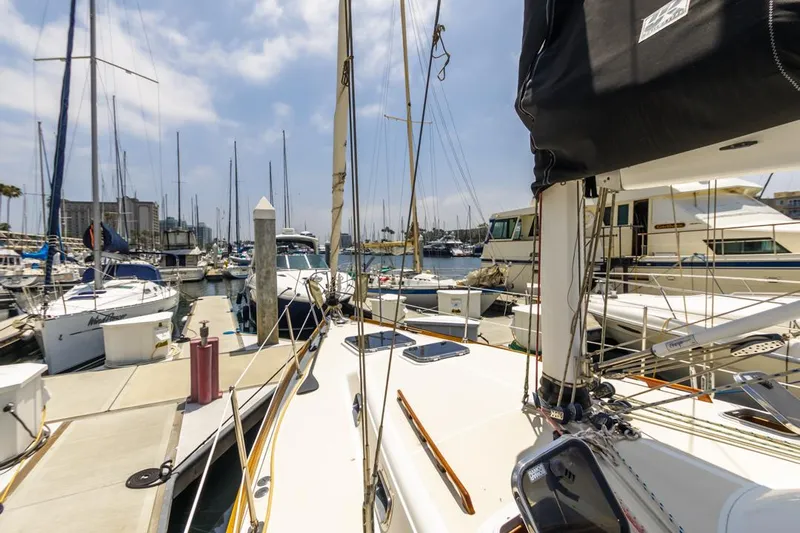 Kamala Yacht Photos Pics Sailboats docked at a marina, featuring a 2003 Tartan 3700 under a clear sky.