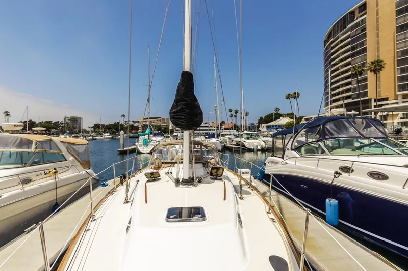 Kamala Yacht Photos Pics Sailboat docked in marina, Tartan 3700, 2003 model, surrounded by other boats and buildings.