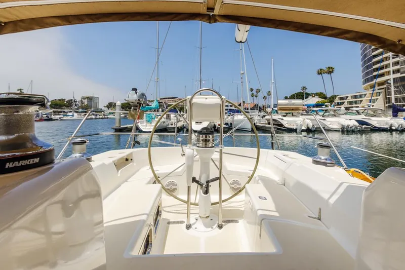Kamala Yacht Photos Pics Tartan 3700 sailboat cockpit view in marina, 2003 model, sunny day, yachts in background.