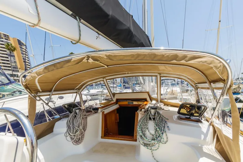 Kamala Yacht Photos Pics Sailboat cockpit of 2003 Tartan 3700 with ropes and canopy in marina.