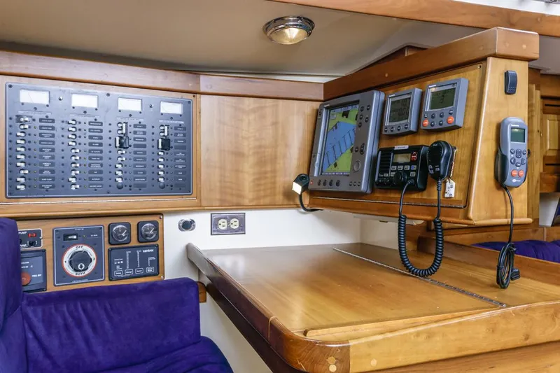 Kamala Yacht Photos Pics Navigation station in a 2003 Tartan 3700 yacht with control panels and electronic displays.