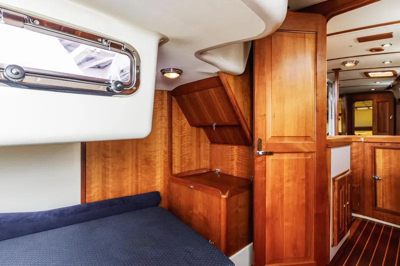 Kamala Yacht Photos Pics Interior of 2003 Tartan 3700 sailboat with wooden cabinetry and cozy sleeping area.