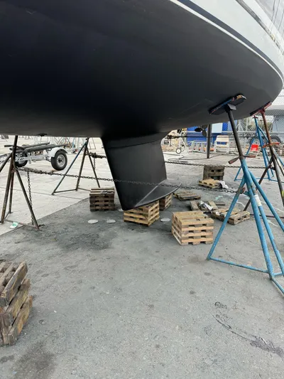 Kamala Yacht Photos Pics Tartan 3700 sailboat from 2003 on stands, showing keel and hull in a boatyard.