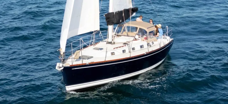 Kamala Yacht Photos Pics Sailing yacht Tartan 3700, 2003 model, cruising on open sea with white sails.