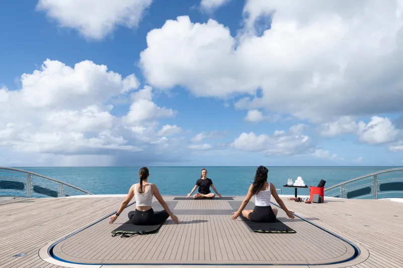 Alfa Nero Yacht Photos Pics Yoga session on Oceanco 269' yacht deck, 2007, with ocean view and blue sky.