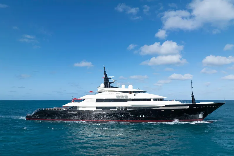 Alfa Nero Yacht Photos Pics Luxurious 2007 Oceanco 269' yacht cruising on open sea under clear blue sky.