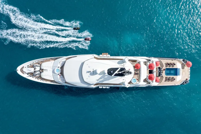 Alfa Nero Yacht Photos Pics Aerial view of 2007 Oceanco 269' yacht with jet skis in turquoise water.