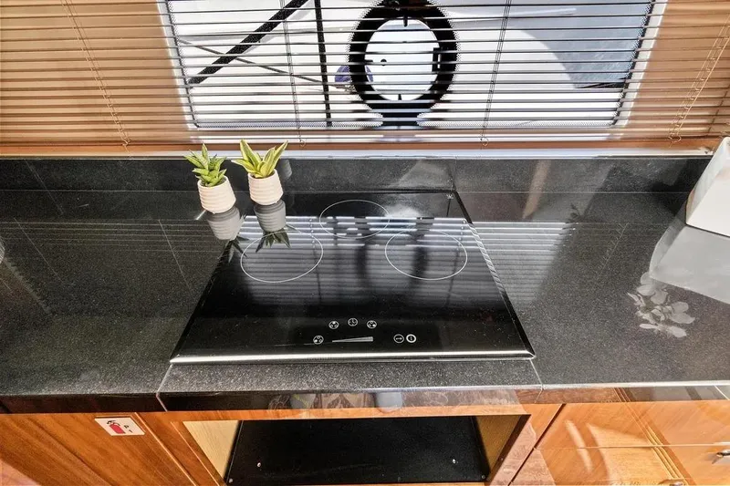  Yacht Photos Pics Modern kitchen in 2017 Sunseeker 68 Sport Yacht with sleek cooktop and potted plants.