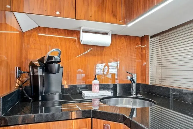  Yacht Photos Pics Luxurious kitchen area in 2017 Sunseeker 68 Sport Yacht with coffee maker and sink.