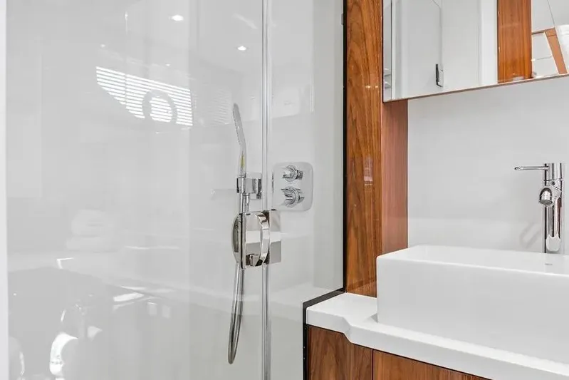  Yacht Photos Pics Luxurious bathroom in 2017 Sunseeker 68 Sport Yacht with modern fixtures and wood accents.