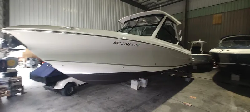  Yacht Photos Pics 2021 Boston Whaler 280 Vantage boat in storage, side view.