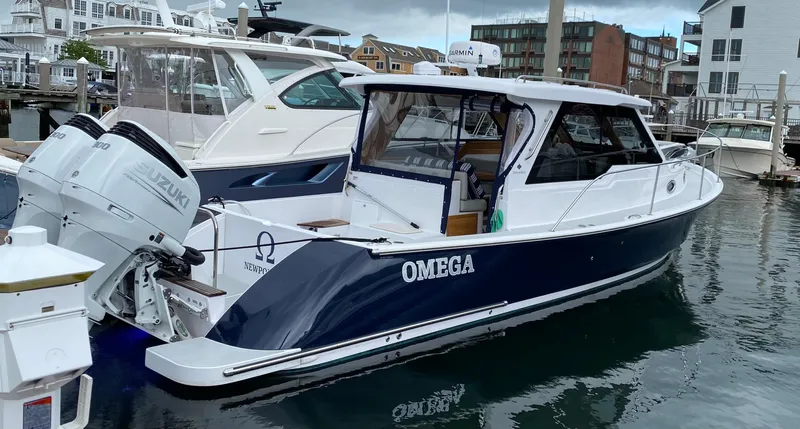 Omega Yacht Photos Pics 2022 True North 34 Outboard Express boat docked in marina.