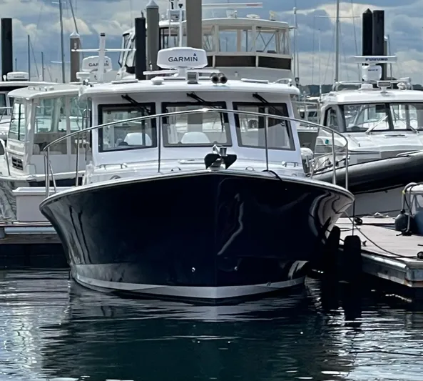 Omega Yacht Photos Pics 2022 True North 34 Outboard Express boat docked at marina, front view.