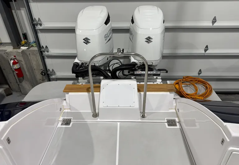 Omega Yacht Photos Pics 2022 True North 34 Outboard Express boat with dual Suzuki engines in a garage.