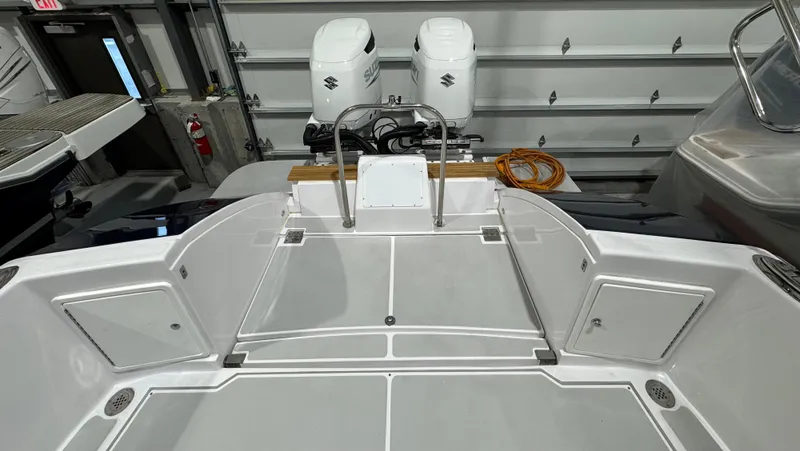 Omega Yacht Photos Pics 2022 True North 34 Outboard Express boat with dual engines in a garage.