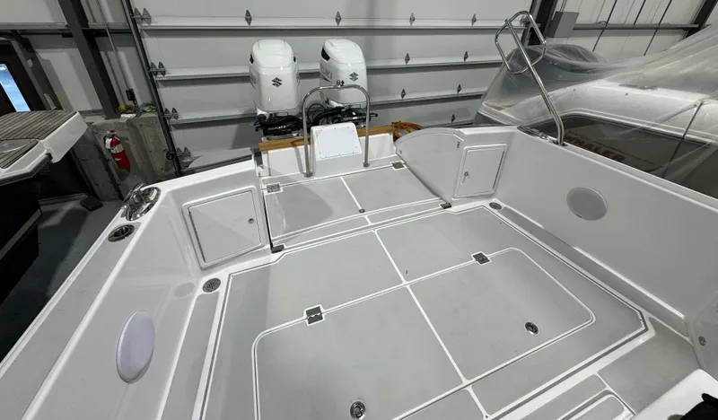 Omega Yacht Photos Pics 2022 True North 34 Outboard Express boat interior with dual engines in a garage.