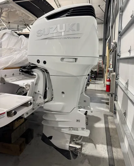 Omega Yacht Photos Pics 2022 True North 34 Outboard Express with Suzuki engine in a garage setting.