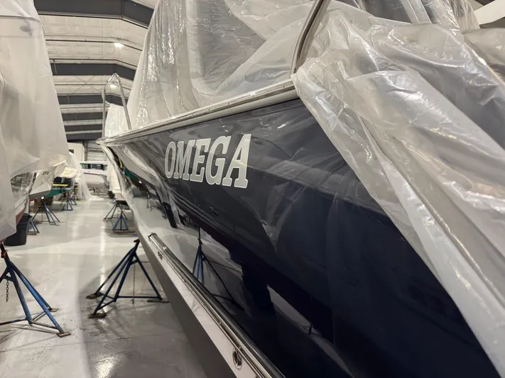 Omega Yacht Photos Pics 2022 True North 34 Outboard Express boat named "Omega" covered in protective plastic.