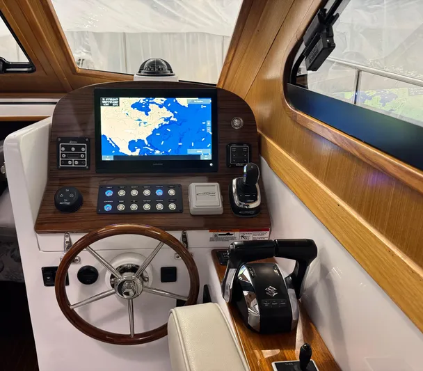 Omega Yacht Photos Pics 2022 True North 34 Outboard Express helm with navigation display and controls.