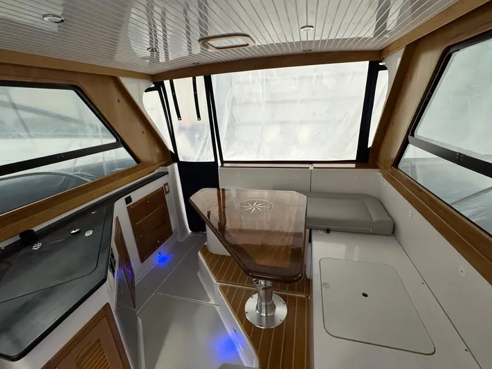 Omega Yacht Photos Pics Interior of 2022 True North 34 Outboard Express with modern seating and wooden accents.