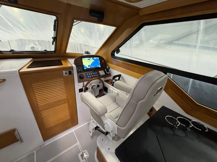 Omega Yacht Photos Pics Interior of 2022 True North 34 Outboard Express boat with modern helm and navigation system.
