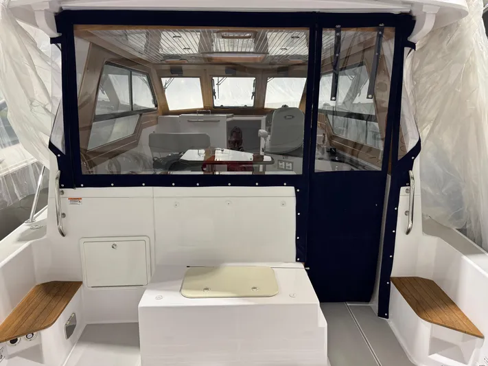 Omega Yacht Photos Pics 2022 True North 34 Outboard Express boat interior with seating and helm.