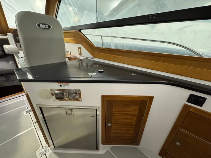 Omega Yacht Photos Pics 2022 True North 34 Outboard Express interior with sleek counter and wooden cabinetry.