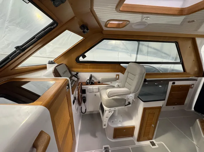Omega Yacht Photos Pics 2022 True North 34 Outboard Express interior with helm station and seating.