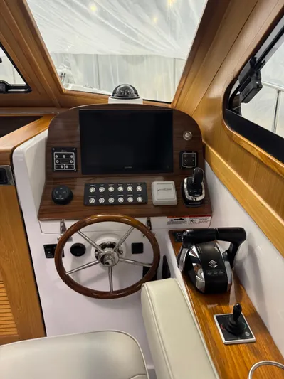 Omega Yacht Photos Pics 2022 True North 34 Outboard Express helm with wooden accents and modern controls.