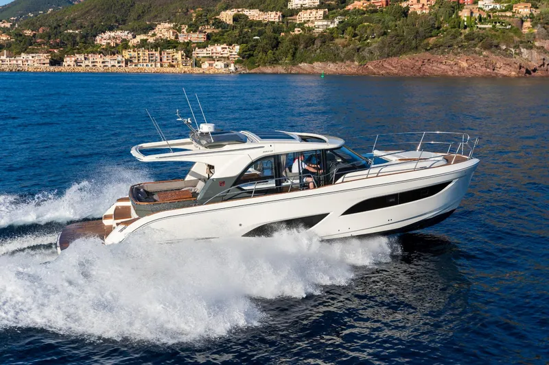  Yacht Photos Pics 2026 Marex 440 Gourmet Cruiser yacht navigating coastal waters, scenic backdrop.