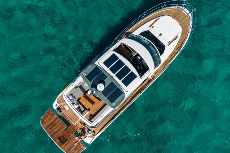  Yacht Photos Pics Aerial view of 2026 Marex 440 Gourmet Cruiser on clear turquoise water.